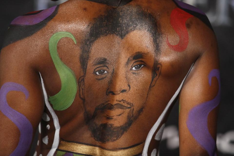 Janeshia Adams-Ginyard, with a portrait of late actor Chadwick Boseman painted on her back, attends the premiere of Marvel's 'Black Panther: Wakanda Forever'