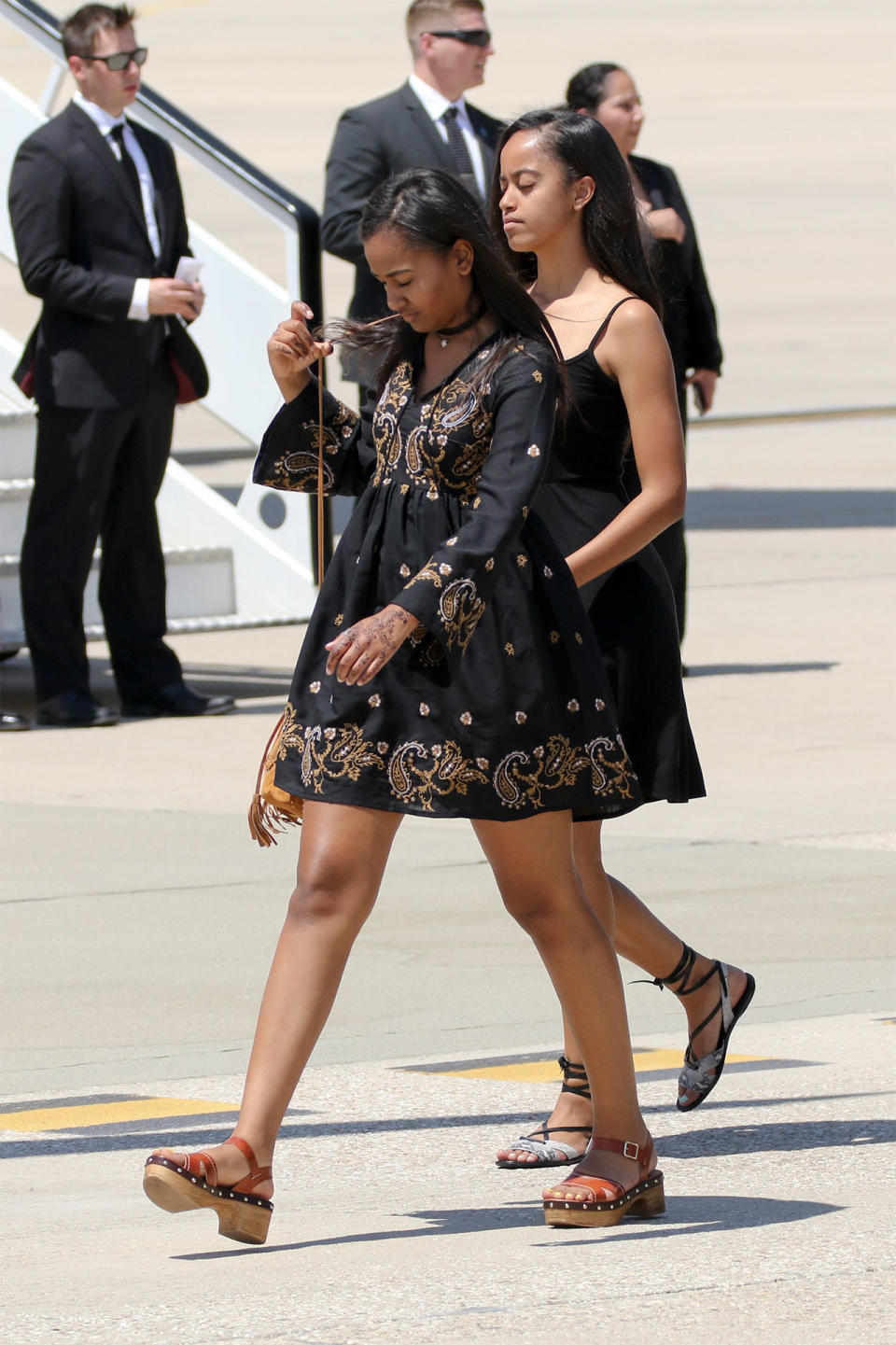 <p>Putting their own summery spin on the daytime LBD, Sasha and Malia's ensembles are punctuated by statement sandals.</p> <h4>Getty Images</h4>