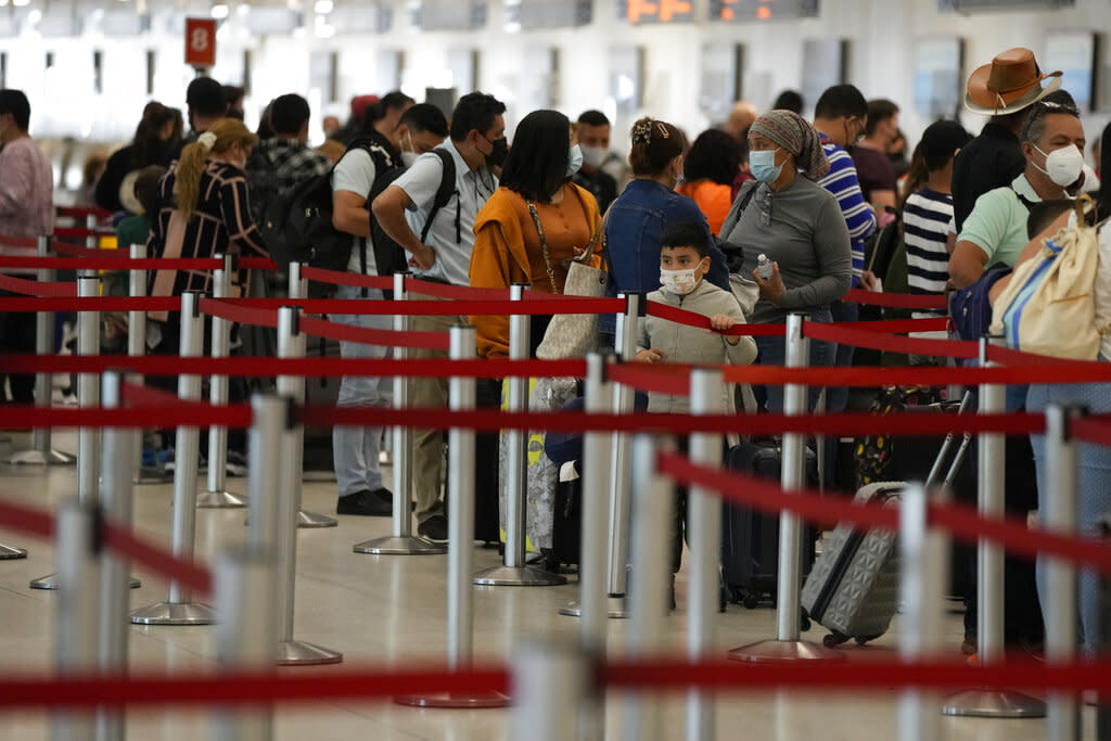 Travelers at Miami International Airport were met with cancellations and delays Monday as airlines grappled with staffing shortages due to the rapid spread of the omicron variant of the coronavirus. (AP Photo/Rebecca Blackwell)