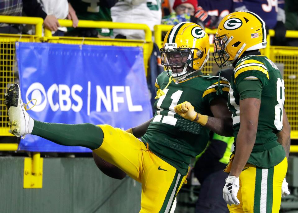 Green Bay Packers wide receiver Jayden Reed (11) and wide receiver Bo Melton (80) celebrate a reception against the Chicago Bears during their football game at Lambeau Field.