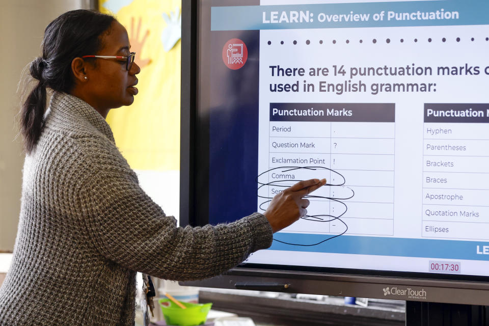 S'Heelia Marks gives instruction to students to prepare them for the digital SAT, Wednesday, March 6, 2024, at Holy Family Cristo Rey Catholic High School in Birmingham, Ala. (AP Photo/Butch Dill)
