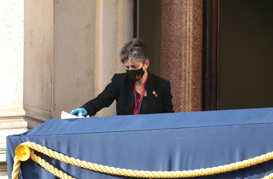 A worker wipes down the Royal box ahead of the the Remembrance Sunday ceremony at the Cenotaph on Whitehall in central London, on November 8, 2020. - Remembrance Sunday is an annual commemoration held on the closest Sunday to Armistice Day, November 11, the anniversary of the end of the First World War and services across Commonwealth countries remember servicemen and women who have fallen in the line of duty since WWI. This year, the service has been closed to members of the public due to the novel coronavirus COVID-19 pandemic. (Photo by Chris Jackson / POOL / AFP) (Photo by CHRIS JACKSON/POOL/AFP via Getty Images)