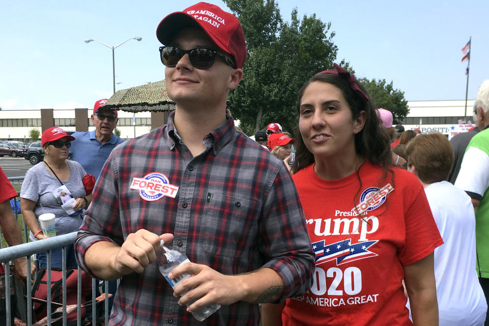 Ashley Arentz, 28, of Jacksonville, N.C., waits in line with friend Jonathan Ritter to enter a rally that President Donald Trump staged for Republican congressional candidate Dan Bishop in Fayetteville, N.C., Monday, Sept. 9, 2019. Arentz, a Marine, said she signed up to vote at the rally. Trump’s campaign is on the hunt for political unicorns: Trump’s team is searching for people in battleground states who support the president but didn’t vote in 2016. (AP Photo/Alan Fram)