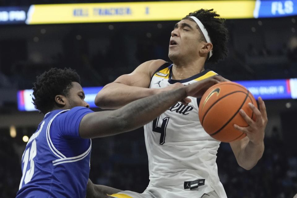 Seton Hall's Jaquan Sanders fouls Marquette's Stevie Mitchell during the first half of an NCAA college basketball game Saturday, Jan. 27, 2024, in Milwaukee. (AP Photo/Morry Gash)