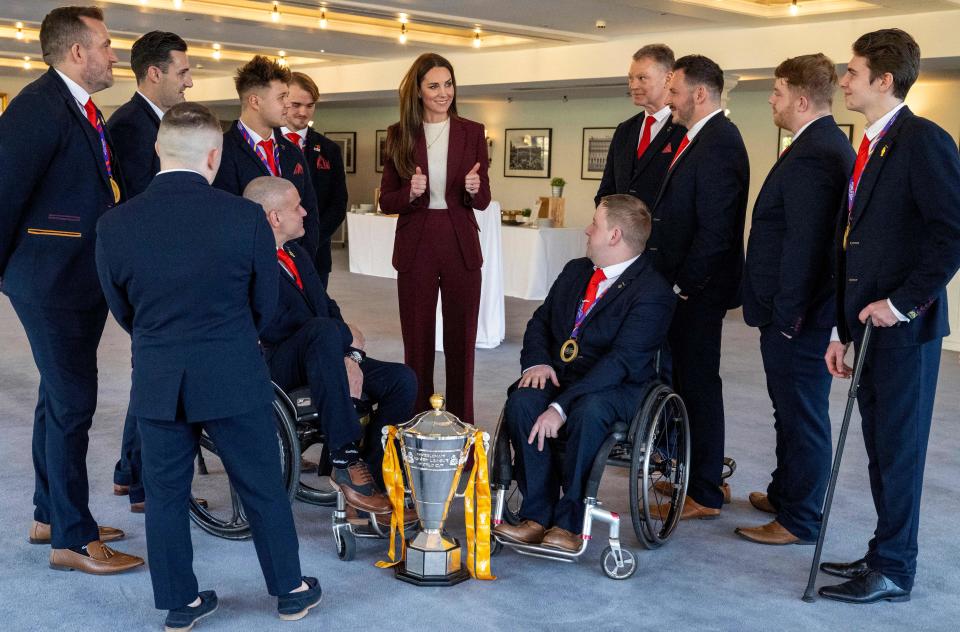 Britain's Catherine, Princess of Wales (C) talks with players and coaching staff as she hosts a reception in recognition of the success of the England Wheelchair Rugby League team at the recent Rugby League World Cup, at Hampton Court Palace in southwest London on January 19, 2023. (Photo by Mark Large / POOL / AFP) (Photo by MARK LARGE/POOL/AFP via Getty Images)