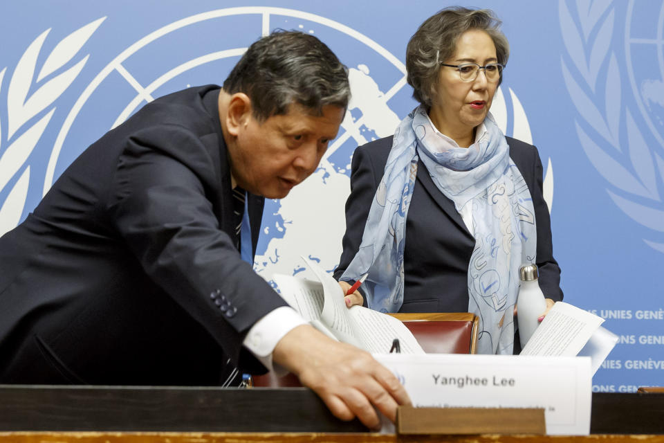 Marzuki Darusman, left, chairperson of the Independent International Fact-finding Mission on Myanmar and Yanghee Lee, Special Rapporteur on the situation of human rights in Myanmar, removes a placard identifying a name prior a press conference about the main findings of the UN Special Rapporteur on human rights in Myanmar and the Independent International Fact-Finding Mission on Myanmar, at the European headquarters of the United Nations in Geneva, Switzerland, Tuesday, Sept. 17, 2019. (Salvatore Di Nolfi/Keystone via AP)