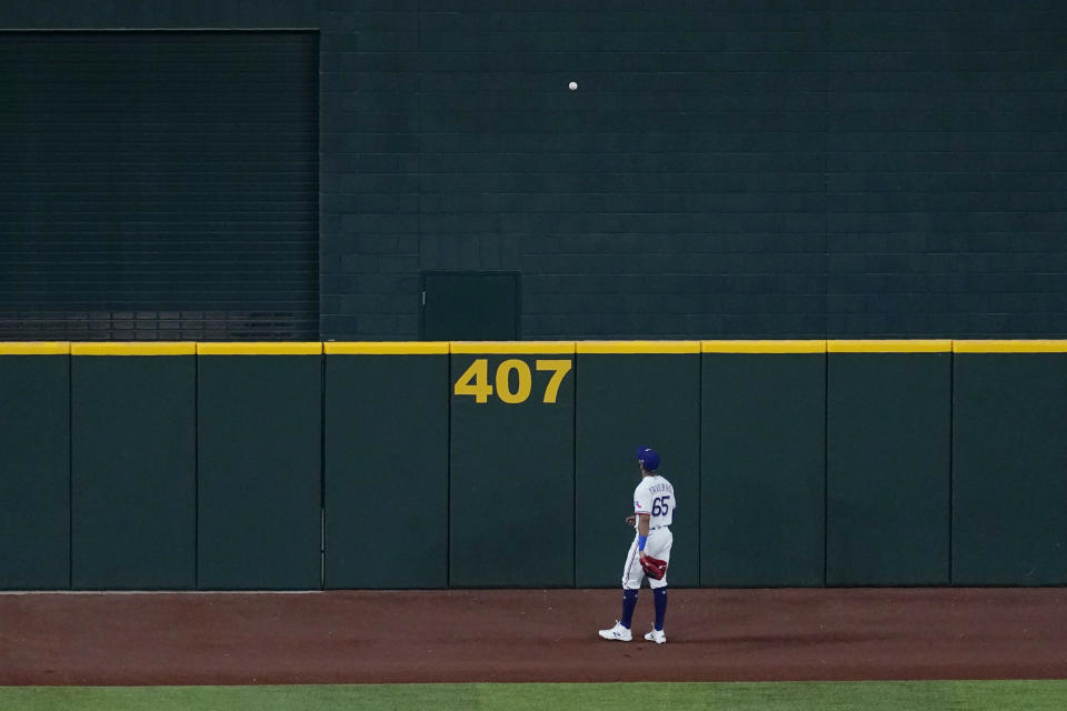 Texas Rangers center fielder Leody Taveras watches the ball on a home run by Houston Astros' George Springer during the second inning of a baseball game in Arlington, Texas, Thursday, Sept. 24, 2020. (AP Photo/Tony Gutierrez)