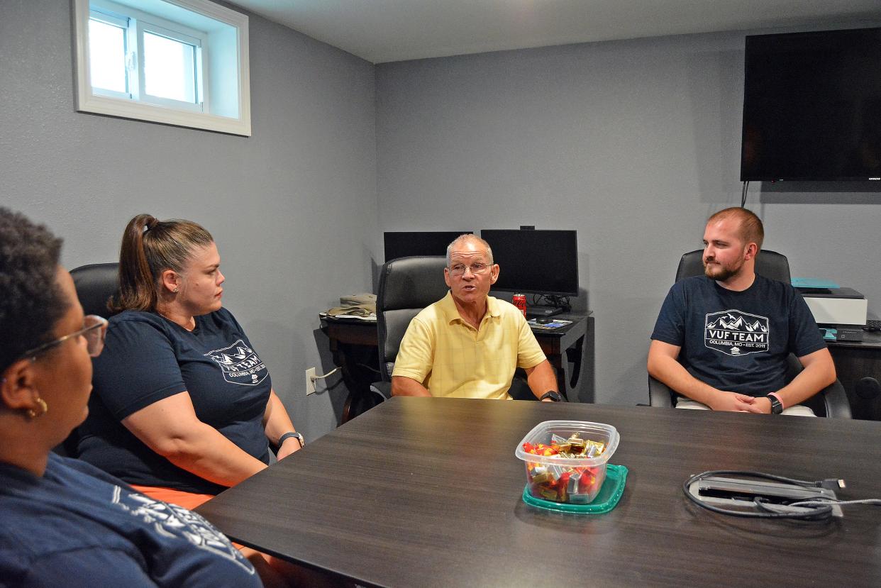 In2Action Executive Director Dan Hanneken, third from left, chats Friday with the Veterans United Foundation team, including Mariah Journey, from left, Piper Brintnall and Brock Wright, at the In2Action offices. He was explaining the program prior to receiving a $100,000 grant in support of In2Action's capital campaign.