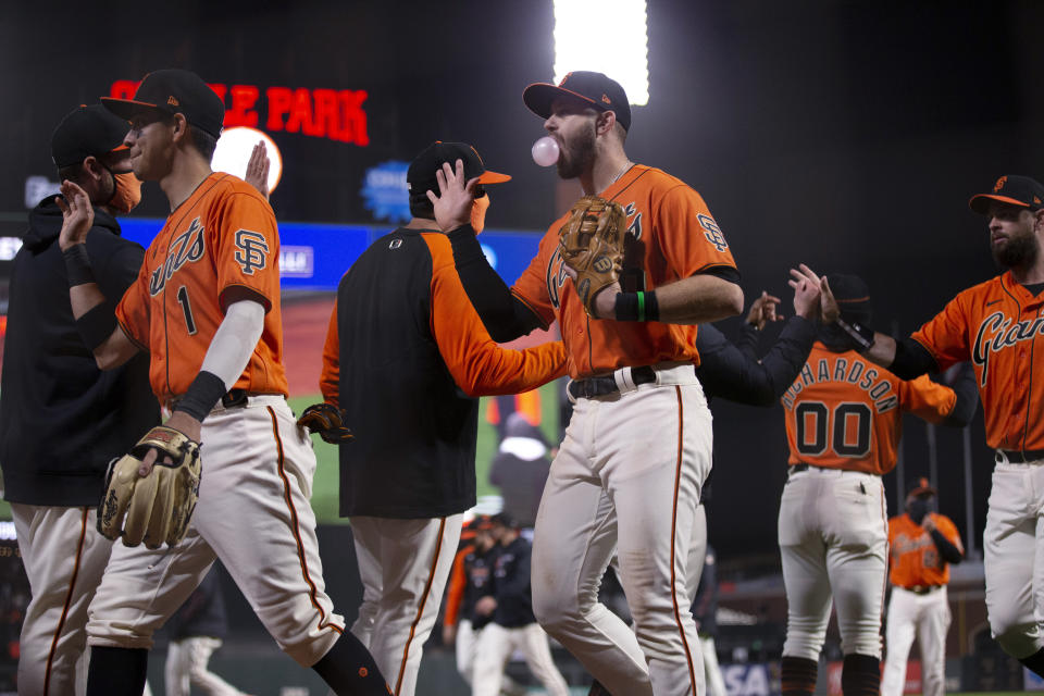 San Francisco Giants celebrate a 5-4 victory over the San Diego Padres in a baseball game Friday, May 7, 2021, in San Francisco. (AP Photo/D. Ross Cameron)