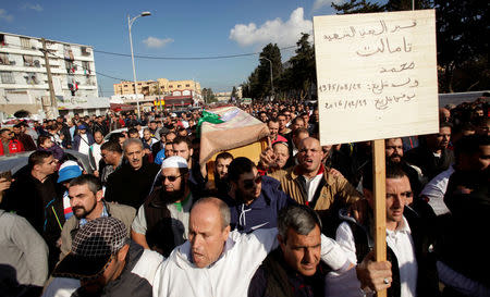 Relatives carry the coffin of British-Algerian journalist Mohamed Tamalt, British-Algerian journalist who had died six months after staging a hunger strike in Algiers over his detention for publishing articles seen as offensive to President Abdelaziz Bouteflika, during his funeral in Algiers, Algeria December 12, 2016. REUTERS/ Ramzi Boudina