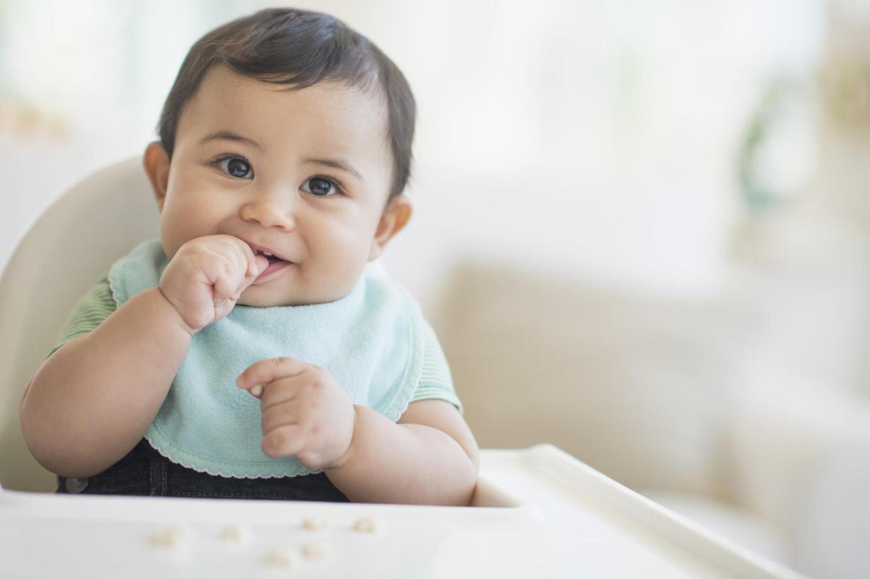 Baby in a high chair eating