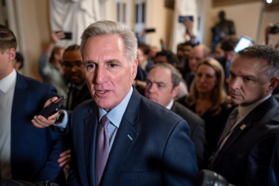 Speaker of the House Kevin McCarthy, R-Calif., is surrounded by press and police on the way to the chamber, at the Capitol in Washington, Tuesday, Oct. 3, 2023. McCarthy’s ability to remain in leadership is now seriously at risk after the House voted to move ahead with an effort by hard-right Republican critics to oust him. Tuesday’s narrow vote was forced by McCarthy’s chief rival, Rep. Matt Gaetz of Florida. (AP Photo/J. Scott Applewhite)