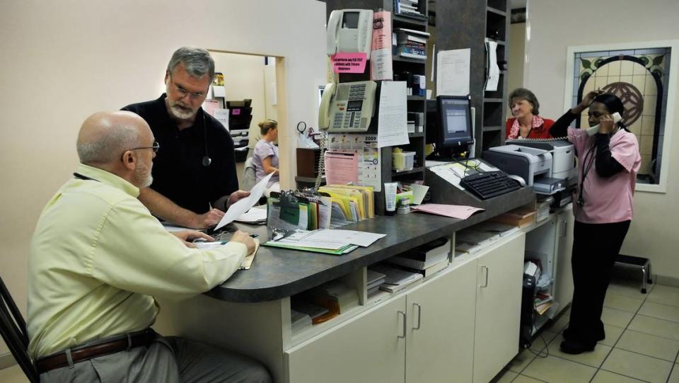 In this 2009 file photo, Dr. Robert Lesslie is standing, second from left, in Riverview Medical Center in Rock Hill.  Lesslie, his wife, two of their grandchildren, and a worker who was at the doctor’s Marshall Road home outside Rock Hill were all shot to death Wednesday, April 7, 2021. 