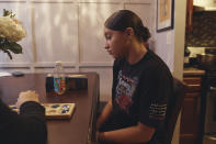 Gabriela Durham, 17, right, plays a game with her sister Gionna Durham, 13, left, partly seen, at their apartment, Saturday, Jan. 27, 2024, in New York. More than ever, teenagers live in a seamless digital and non-digital world in ways that most adults don’t recognize or understand, says Michael Rich, an associate professor of pediatrics at Harvard University. (AP Photo/Andres Kudacki)