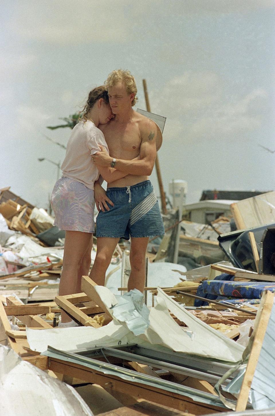 <p>Richard Cilinceon hugs his wife Mitzi at the site of their house trailer which they moved into in June, in Homestead, Fla., Aug. 25, 1992. Hurricane Andrew destroyed the couple’s home and ruined most of their personal possessions. (AP Photo/Kathy Willens) </p>
