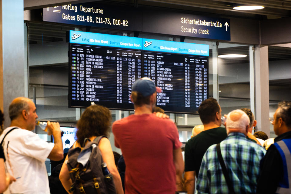 a huge long line of travellers are seen waiting for the securtiy check during the Lufthansa pilot strike at Cologne & Bonn airport in Cologne, Germany on September 2, 2022 (Photo by Ying Tang/NurPhoto via Getty Images)