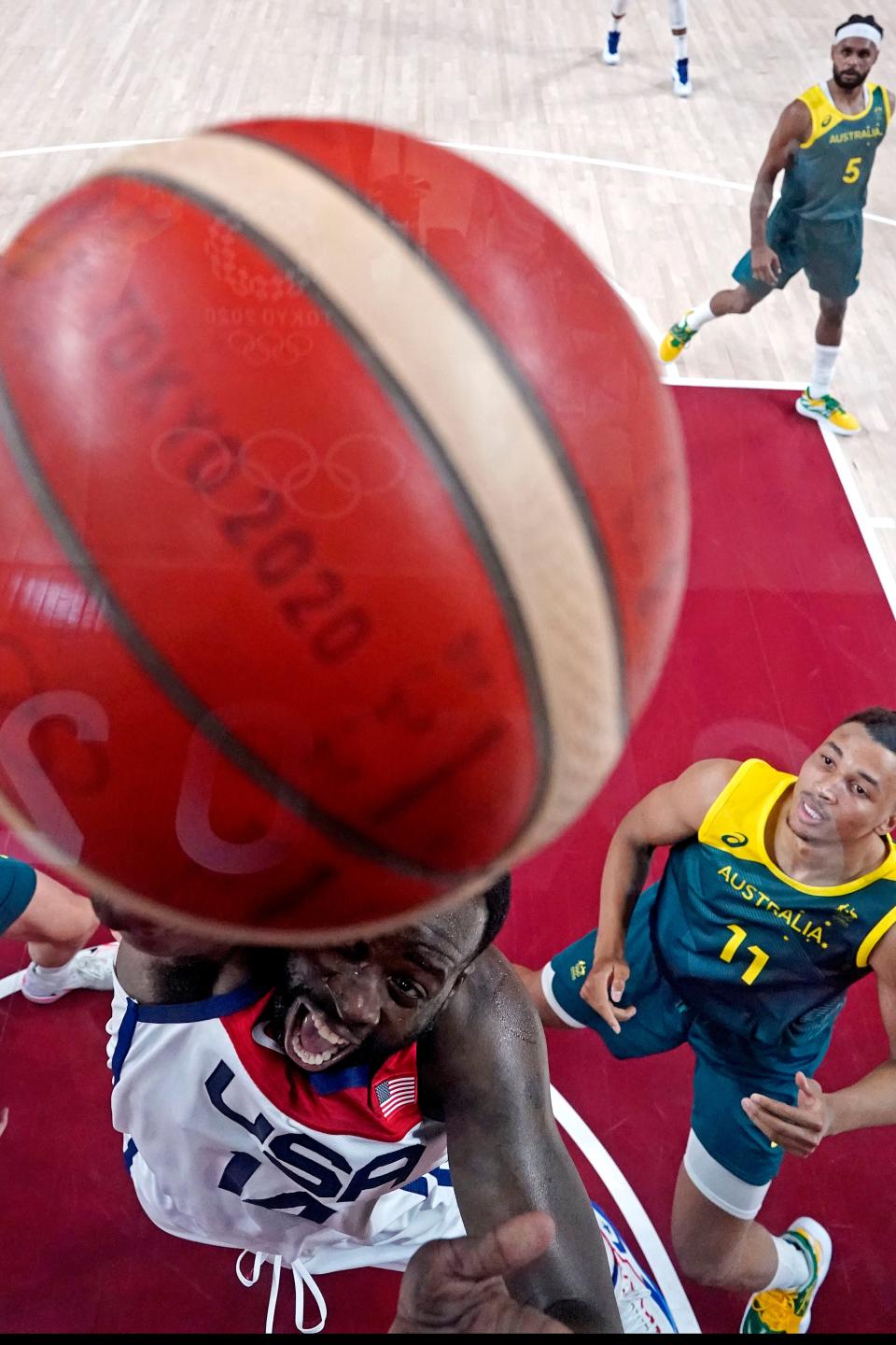 Jrue Holiday shoots against Australia's Dante Exum during the 2020 Summer Games. Holiday is among 11 All-Stars vying for starting spots in Paris.