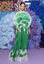 <p>arrives in a pleated green gown with circular fan bodice, plus Bulgari jewels. </p>