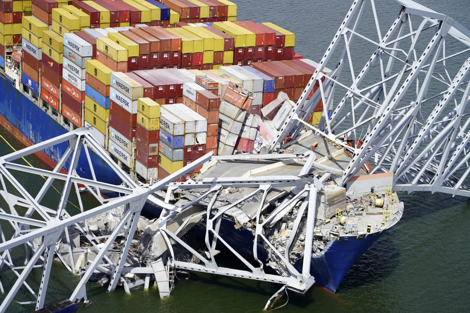 FILE - In this aerial image released by the Maryland National Guard, the cargo ship Dali is stuck under part of the structure of the Francis Scott Key Bridge after the ship hit the bridge, Tuesday, March 26, 2024, in Baltimore. Julio Cervantes Suarez, the only person who survived falling from Maryland's Francis Scott Key Bridge during its catastrophic collapse says he watched in horror as his coworkers, friends and relatives plunged to their deaths. In an exclusive interview with NBC News that aired Wednesday evening, July 10, 2024, he described fighting for his life after his truck tumbled into the Patapsco River. (Maryland National Guard via AP, File)