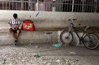 Erik Thiago checks his mobile phone, amid the coronavirus disease (COVID-19) outbreak, in Sao Paulo