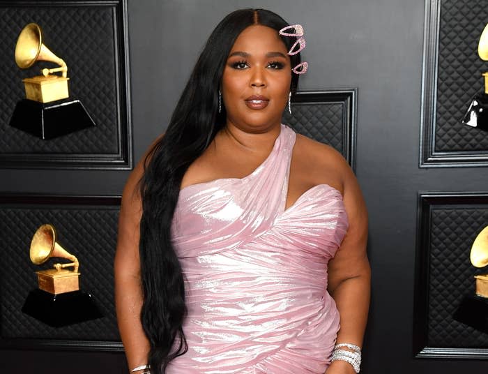 Lizzo wears a shiny pink dress to a red carpet event