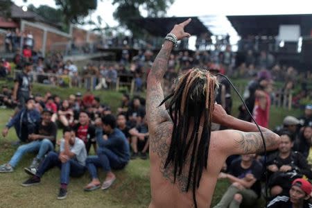 A punk community member sings during punk music festival in Bandung, Indonesia West Java province, March 23, 2017. Picture taken March 23, 2017. REUTERS/Beawiharta