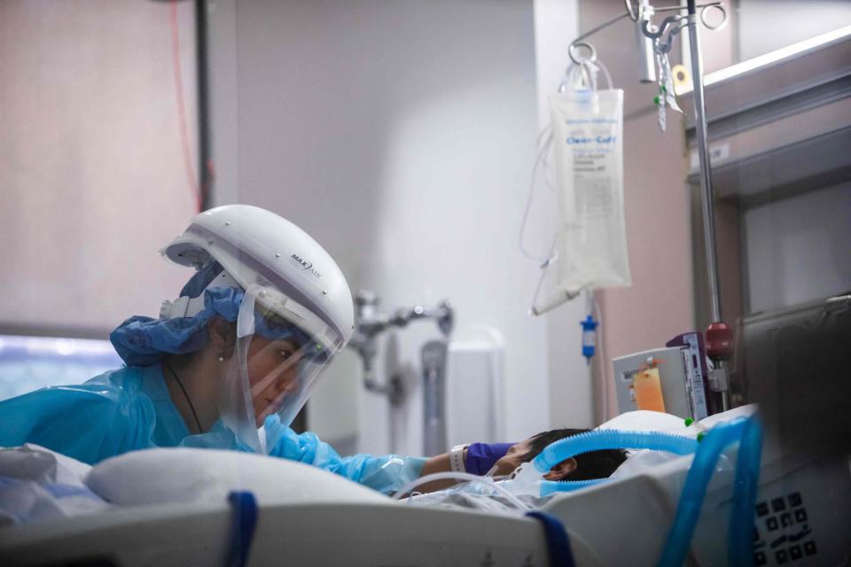 Registered nurse Yeni Sandoval caring for a COVID patient in the ICU at Providence Cedars-Sinai Tarzana Medical Center in Tarzana, Calif., on Jan. 3, 2021.