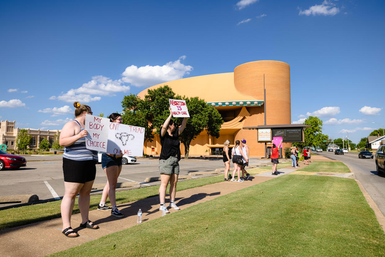 Protesters line the street of Adams Boulevard outside the Bartlesville Community Center Monday to protest the Supreme Court's ruling overturning Roe v. Wade.