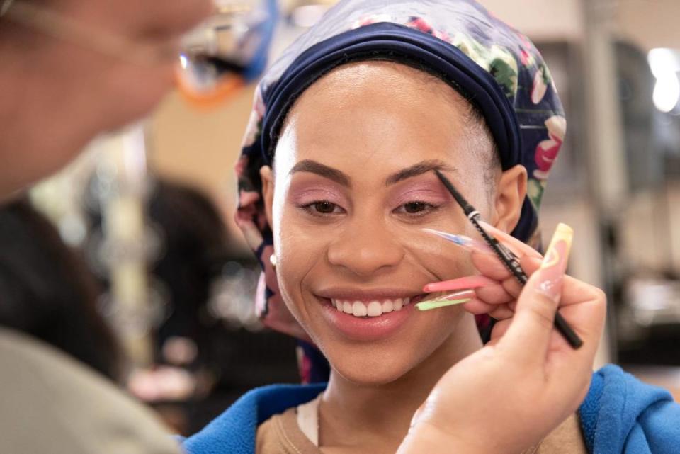 Volunteer makeup artist Somalia Zalzala accentuated eyebrows for Nevaeh Harding before the Miss JuneteenthKC Pageant.