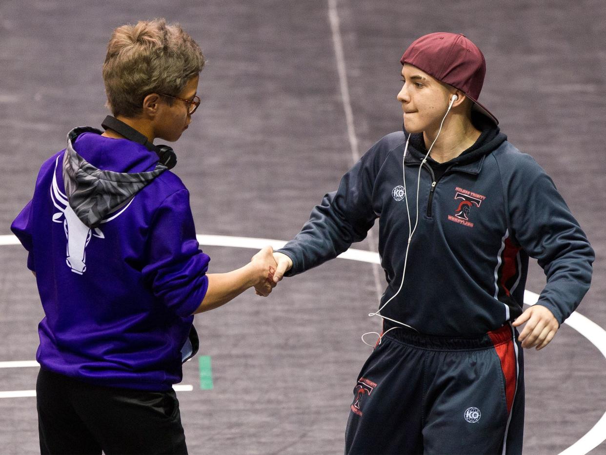 Mack Beggs (right) shakes hands with state championship final opponent Chelsea Sanchez: AP