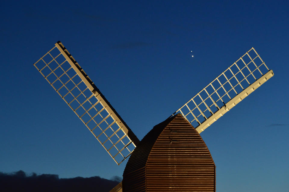 BRILL, ENGLAND - DECEMBER 20:  Jupiter and Saturn are seen coming together in the night sky, over the sails of Brill windmill, for what is known as the Great Conjunction, on December 20, 2020 in Brill, England. The planetary conjunction is easily visible in the evening sky and will culminate on the night of December 21. This is the closest the planets have appeared for nearly 800 years. (Photo by Jim Dyson/Getty Images)