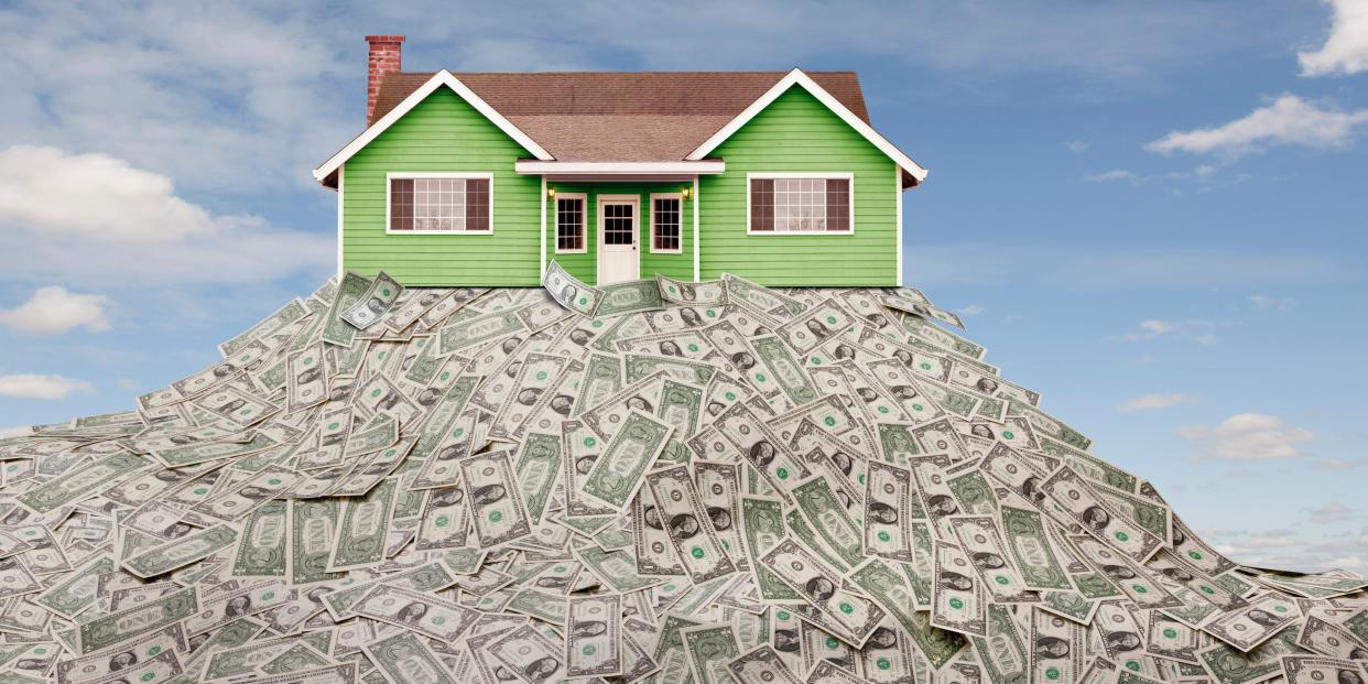 house sitting on a pile of money