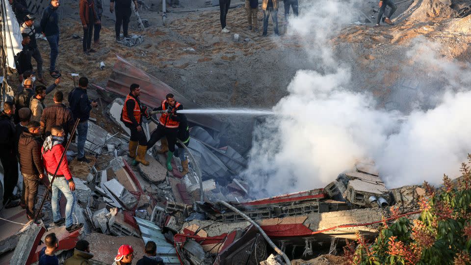 Members of the Palestinian civil defense extinguish a fire in a building following Israeli bombardments east of Rafah in the southern Gaza Strip. - Said Khatib/AFP/Getty Images