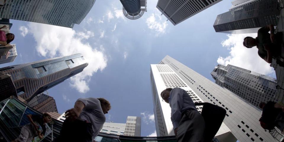 view of people walking by skyscrapers, while looking up