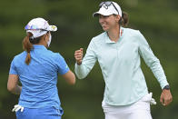 Elizabeth Szokol, right, fist-bumps Nasa Hataoka, of Japan, after putting on the 18th hole during the third round of the Marathon LPGA Classic golf tournament at Highland Meadows Golf Club in Sylvania, Ohio, Saturday, July 10, 2021, in Sylvania, Ohio. (AP Photo/David Dermer)