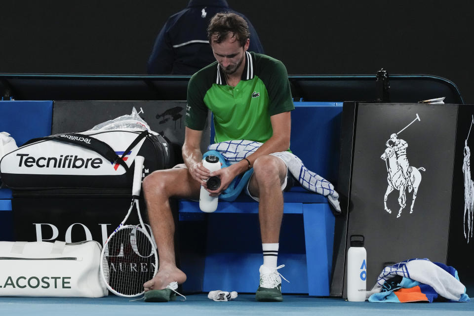 Daniil Medvedev of Russia takes his shoe off to have a blister attended to during his second round match against Emil Ruusuvuori of Finland at the Australian Open tennis championships at Melbourne Park, Melbourne, Australia, Friday, Jan. 19, 2024. (AP Photo/Andy Wong)