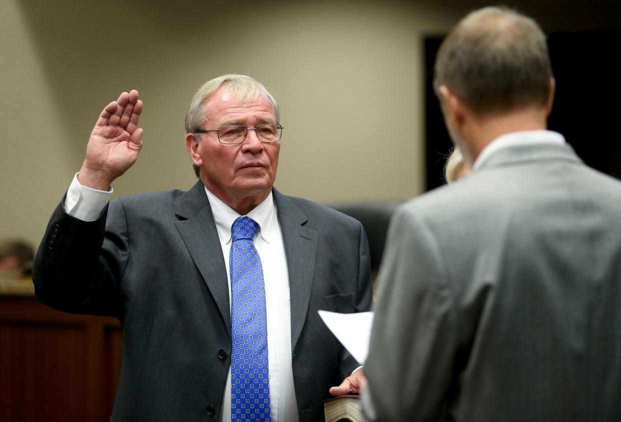 The new Northport mayor and city council were sworn in to office Monday night in the city council chambers at Northport Municipal Center. Bobby Herndon is sworn in as mayor by Scott Collins. [Staff Photo/Gary Cosby Jr.]