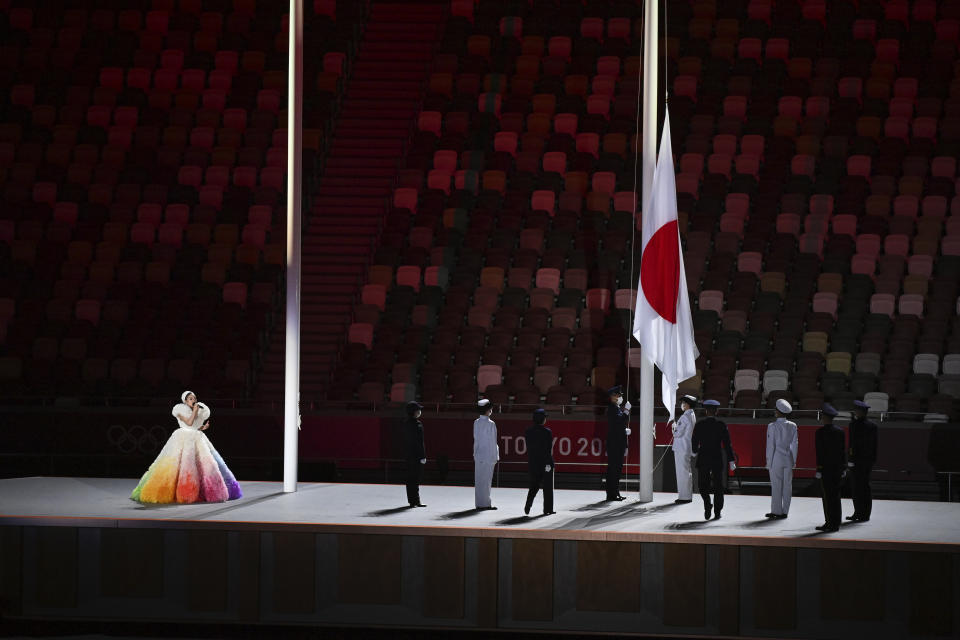 The Japanese flag is hoisted as Misia sings the national anthem during the opening ceremony in the Olympic Stadium at the 2020 Summer Olympics, Friday, July 23, 2021, in Tokyo, Japan. (Dylan Martinez/Pool Photo via AP)