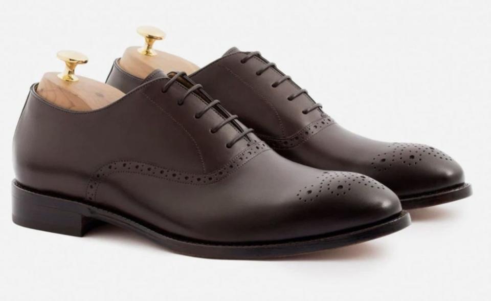Dark brown oxford shoes with laces and decorative stitching at toe and lace lining.