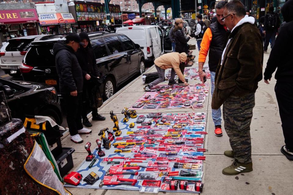 Vendors selling tools on the sidewalk near Roosevelt Avenue. NYPJ for New York Post