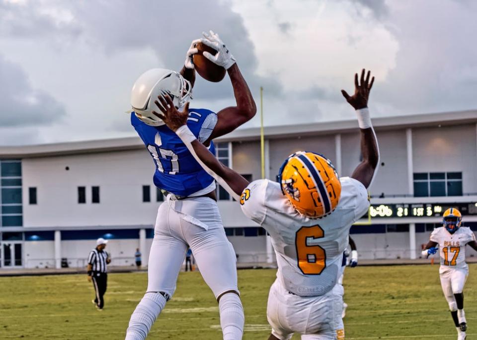 Ascender receiver Carnell Tate hauls in a touchdown pass Friday night at IMG's home game.The defending national champion IMG Academy Ascenders played host the Miami Northwestern Bulls football team 9/10/21.Randall E. Tosch/PAGEMOOREPHOTO