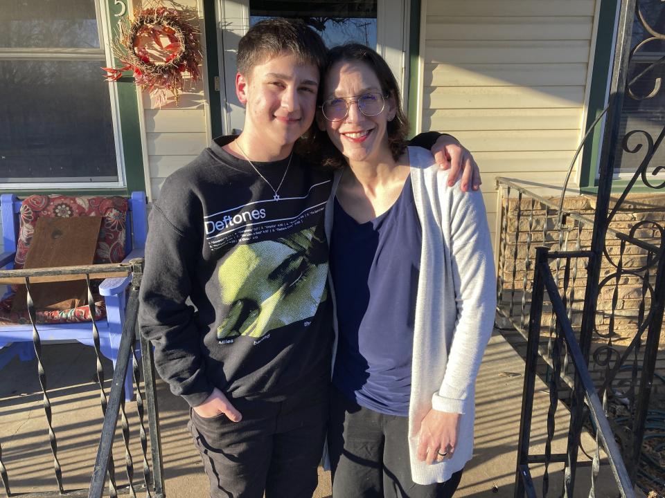 Al Stone-Gebhardt and his mother, Erika Dubose, pose for a photo outside their home on Friday, March 3, 2023, in Tulsa, Okla. As hundreds of bills nationwide take aim at nearly every facet of transgender existence, from health care to athletics to bathroom access, trans kids like Stone-Gebhardt and their families say certain proposals could eliminate one of the last remaining safe havens to explore their identities: K-12 public schools. (AP Photo/Sean Murphy)