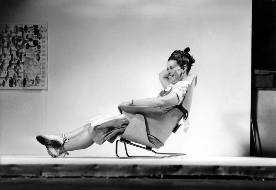 Ray Eames, photographed at the Eames Office studio in Venice, California, in 1946, sits in a prototype of a molded plywood lounge chair.