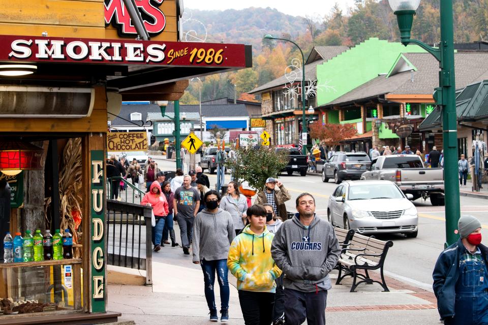 Tourists walk past shops, restaurants and attractions along the busy Parkway in downtown Gatlinburg.