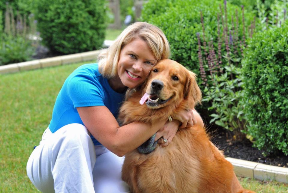 Heather Cyr, of Scituate, and her therapy dog, Tripp, a golden retriever, bring comfort to patients of the NVNA and Hospice. They are in the gardens at the Pat Roche Hospice Home in Hingham, Wednesday, June 28, 2023.