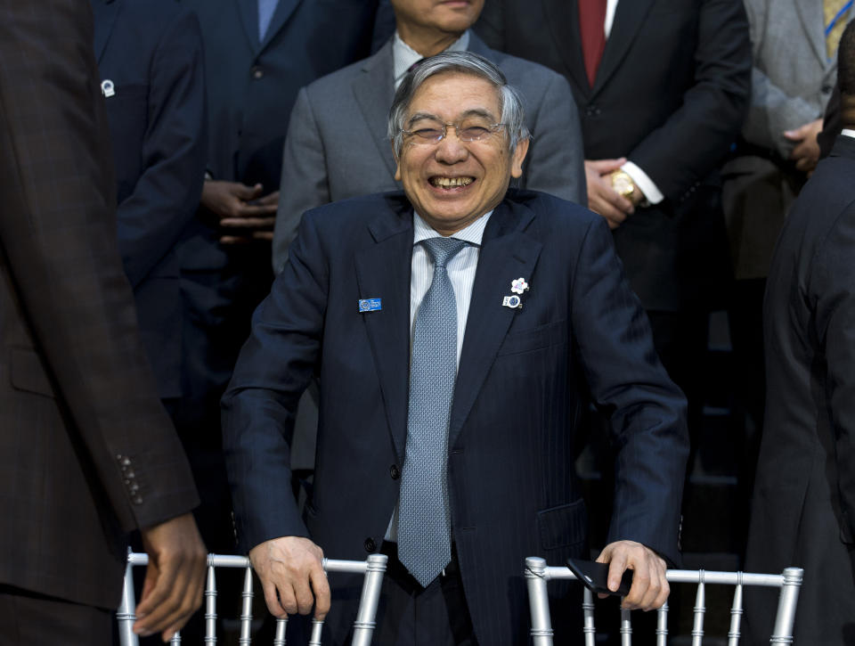 Bank of Japan Governor Haruhiko Kuroda smiles during the International Monetary Fund IMF Governors group photo a at the World Bank/IMF Annual Meetings in Washington, Saturday, Oct. 19, 2019. (AP Photo/Jose Luis Magana)