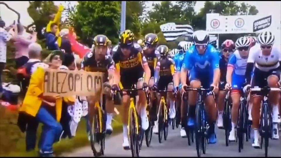 Tony Martin, left, rides into a fan’s banner (ITV)