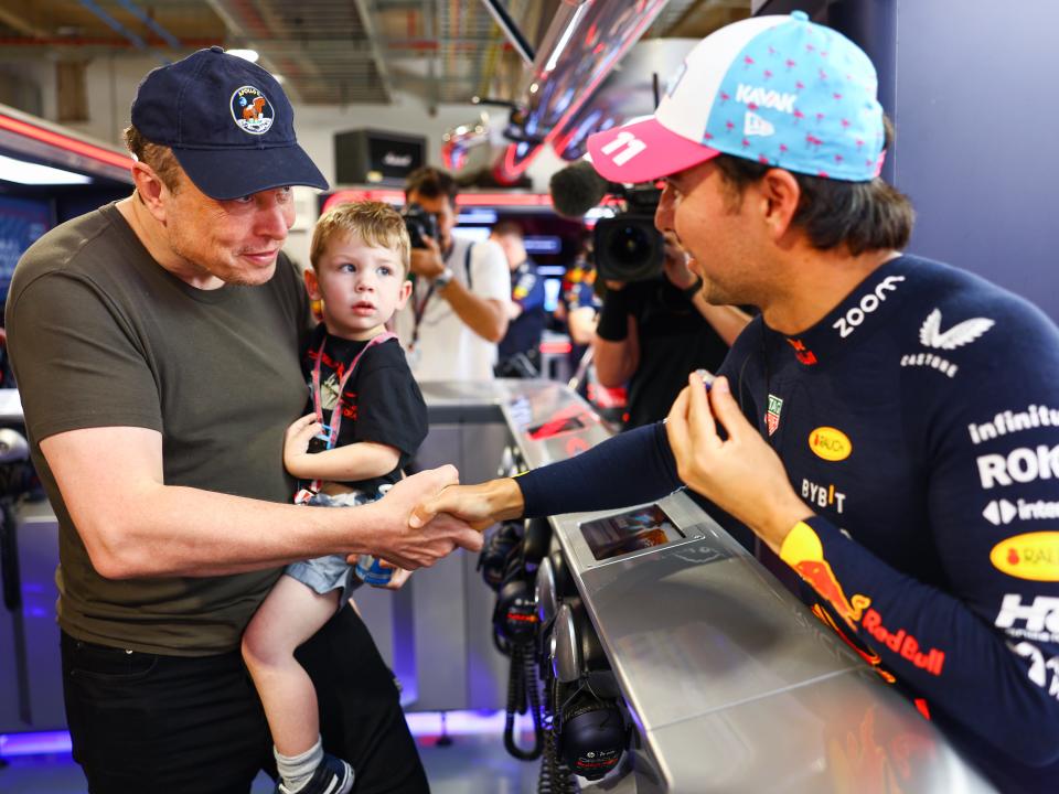 Elon Musk shakes hands with Sergio Perez of Mexico.