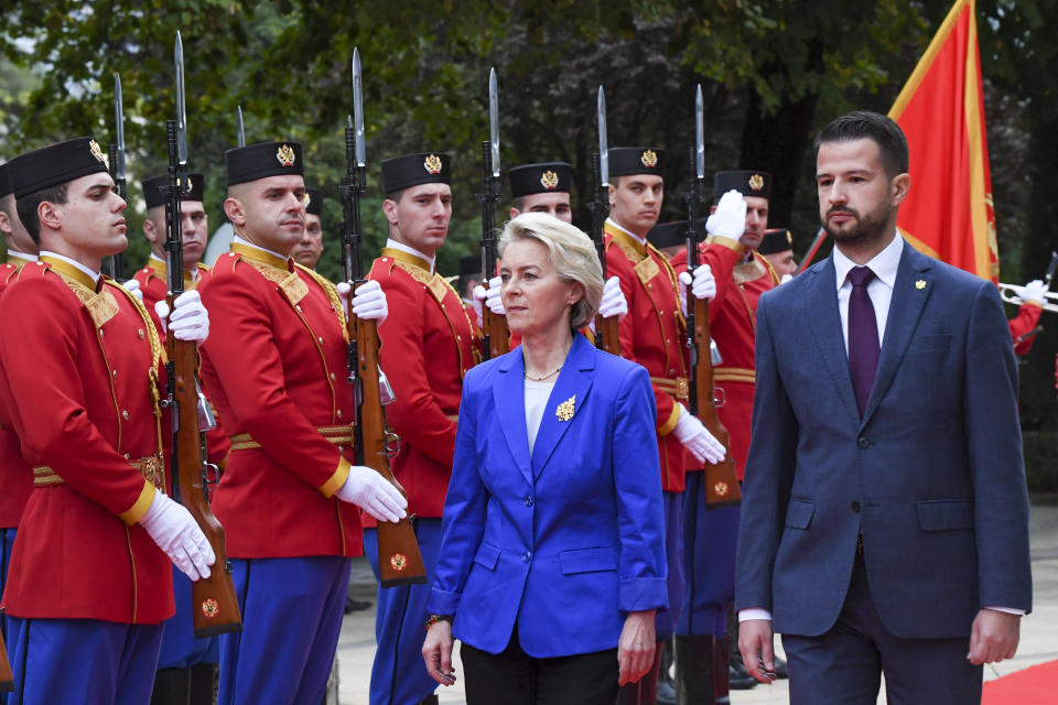 European Commission President Ursula von der Leyen, center left, reviews the honour guard with Montenegro's President Jakov Milatovic in Montenegro's capital Podgorica, Tuesday, Oct. 31, 2023. Von der Leyen is on a one day official visit to Montenegro. (AP Photo/Risto Bozovic)