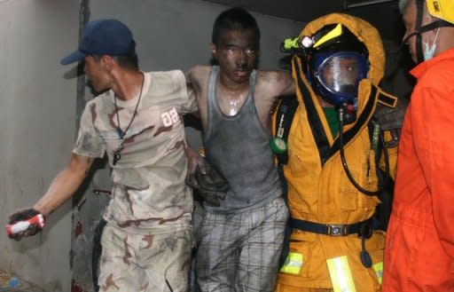 Thai firemen carry an injured man after a fire at the Lee Gardens Hotel in Hat Yai, on March 31. Three people were killed and dozens injured in the fire, in the largest city in southern Thailand, according to officials